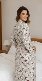 Woman wearing a floral robe in a bedroom setting