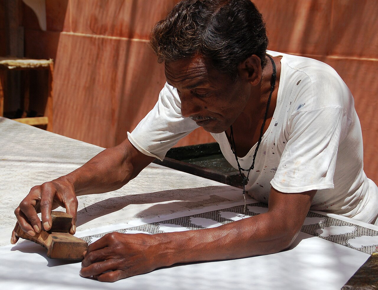 Artisan hand block printing fabric in Jaipur